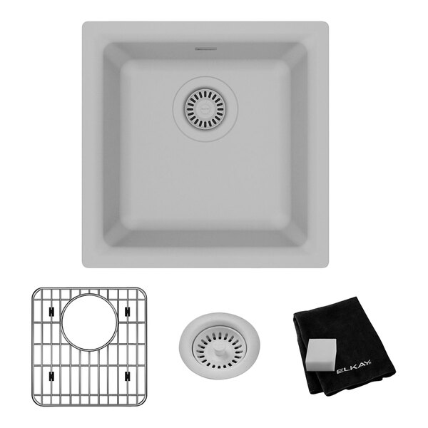 A Zurn Elkay white quartz bar sink with a white drain cover.