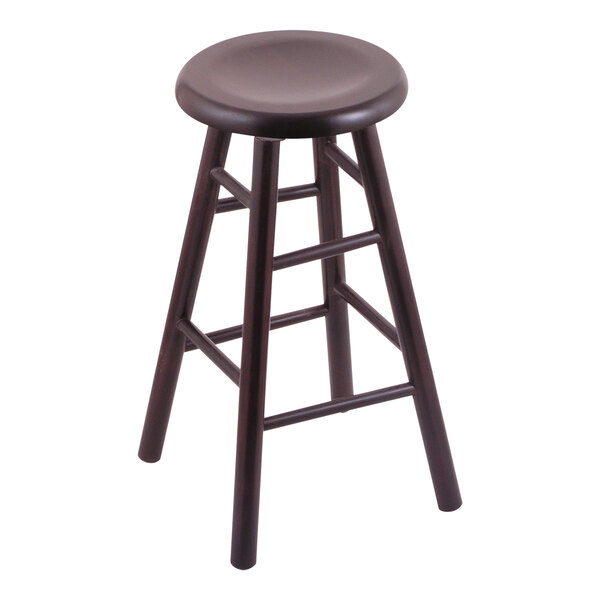 A close-up of a Holland Bar Stool with a swivel seat and dark cherry finish.