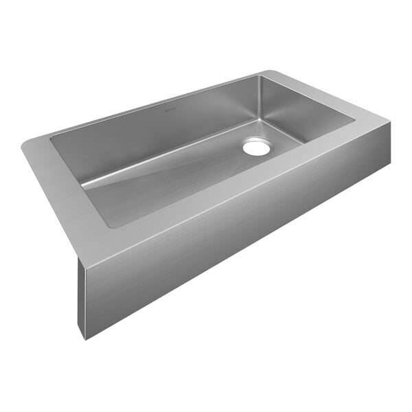 A Zurn Elkay stainless steel farmhouse sink with a drain installed.