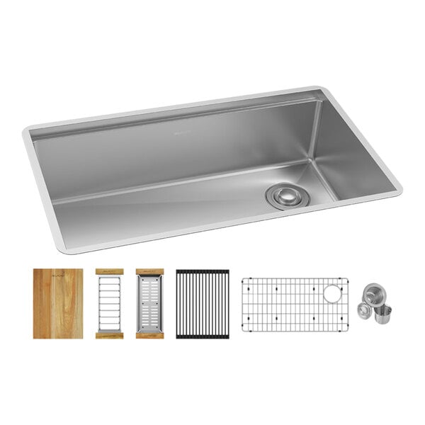 A Zurn Elkay stainless steel undermount sink with a drain and different items inside.