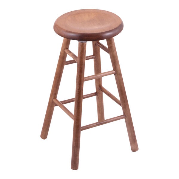 A Holland Bar Stool maple swivel restaurant bar stool with a seat and back.