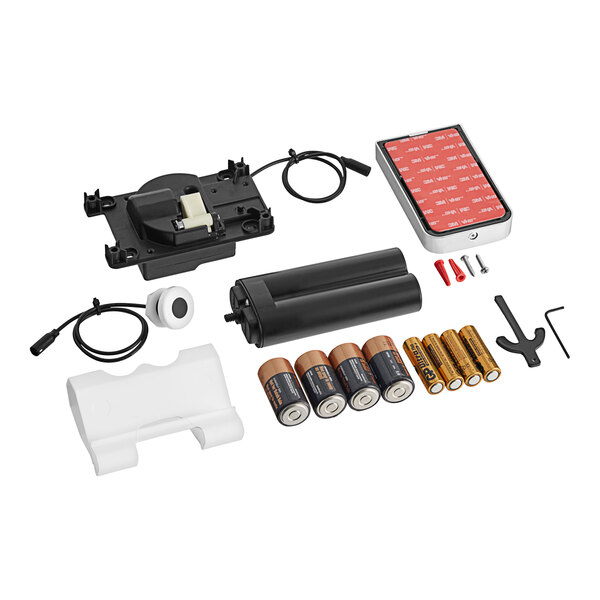 A Flushmate I-Flush on-wall sensor system battery kit with batteries and charger.