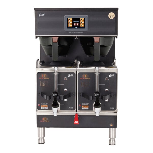 A commercial twin satellite coffee brewer with two dispensing spouts, a digital control panel, and stainless steel construction.