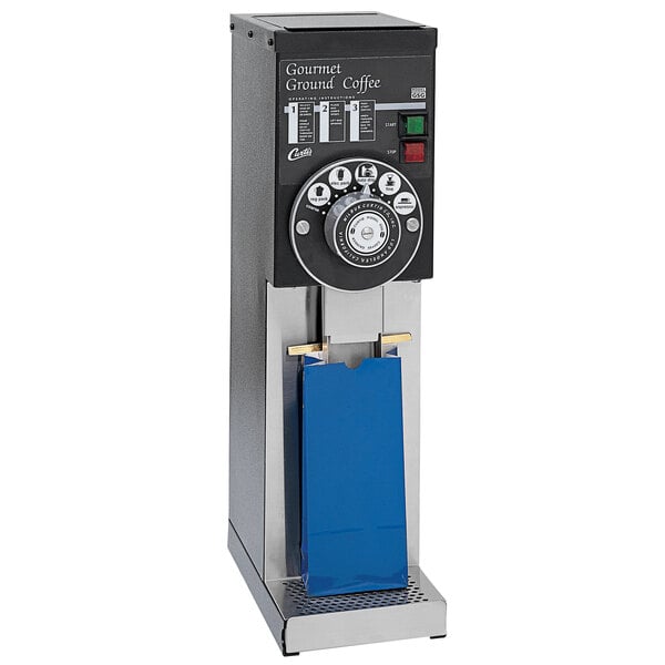 A Curtis commercial coffee grinder with a blue bag on top.