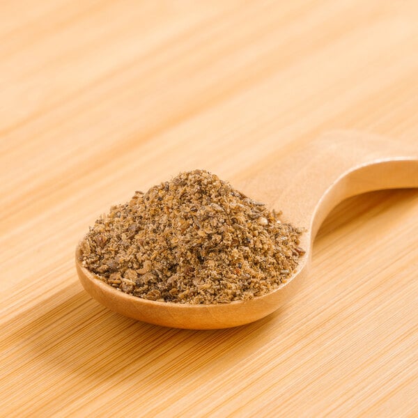 A wooden spoon filled with brown Rainforest Supply Chia Powder.