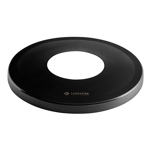 A black circular lid with a hole in the center.