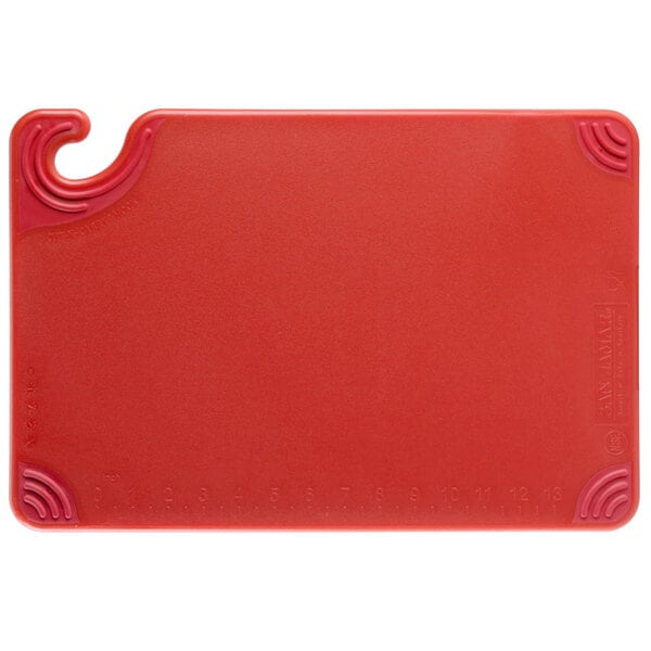 A San Jamar red plastic cutting board with a hook.