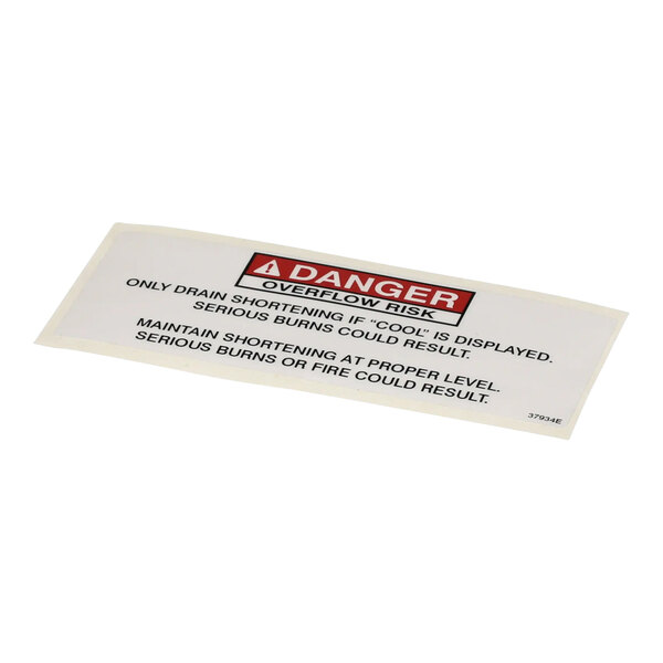 A white rectangular sign with black text that reads "Danger Shortening"