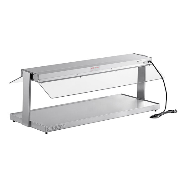 A ServIt stainless steel heated buffet warmer with glass top on a counter.