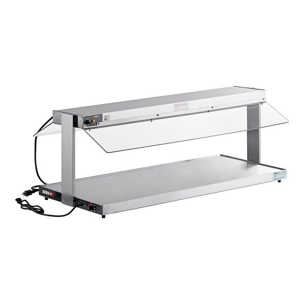 A ServIt stainless steel heated buffet warmer with glass top on a counter.