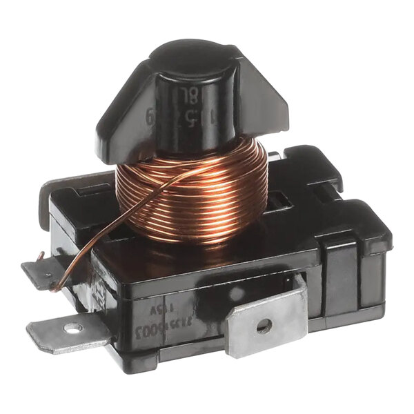 A close up of a black and copper wire coil with a black plastic capacitor.