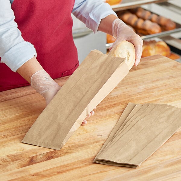 A hand holding a Choice Kraft bread bag full of bread.