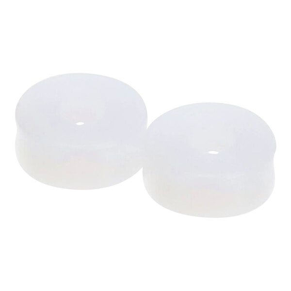 A pair of white plastic discs with holes in them.