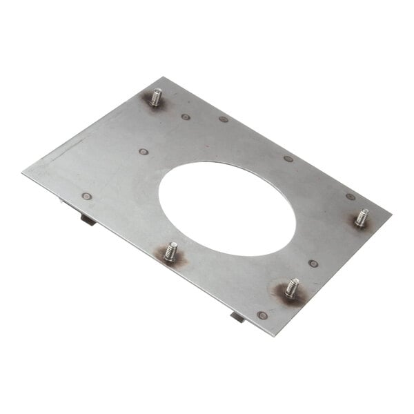 A metal plate with a hole in it and screws on it.