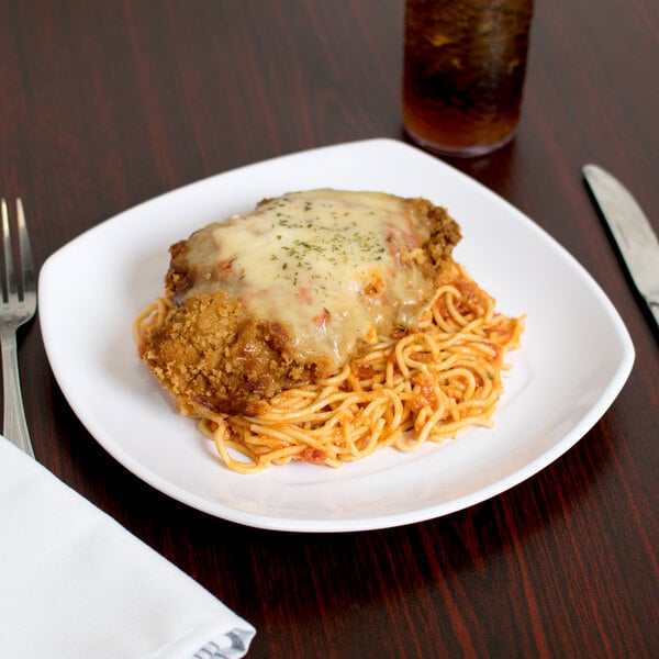 A Carlisle white square melamine plate with spaghetti and meatballs on it.