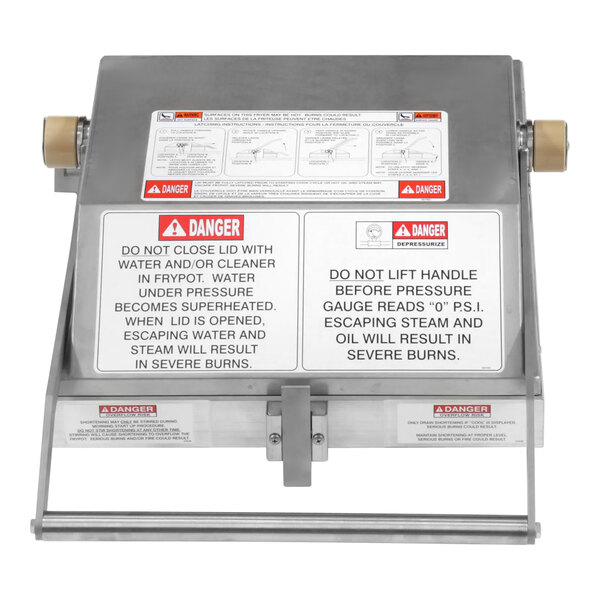 The assembly lid and cover for a Henny Penny fryer on a counter in a school kitchen.