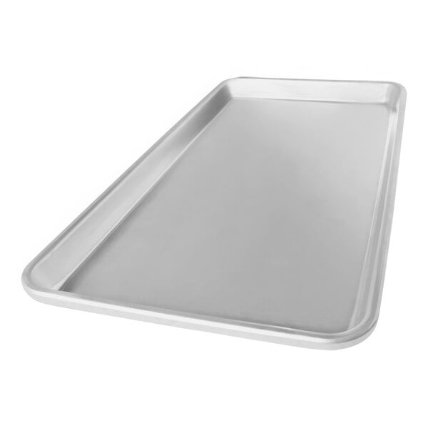 A Chicago Metallic 1/3 size aluminum bun/sheet pan on a counter.