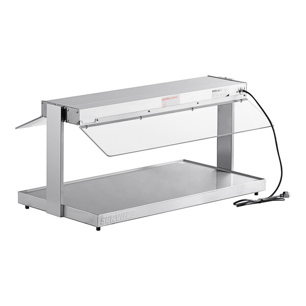 A silver metal ServIt heated buffet warmer with a glass top.
