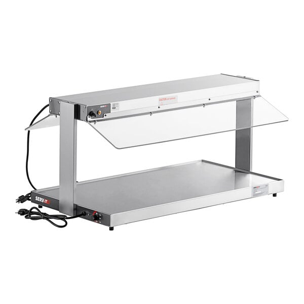 A silver ServIt stainless steel heated buffet warmer with a clear glass top on a counter.