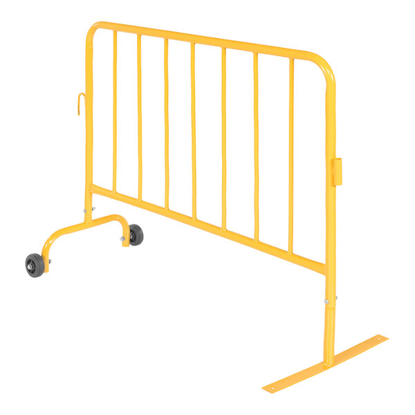 A yellow steel crowd control barrier with wheeled feet.