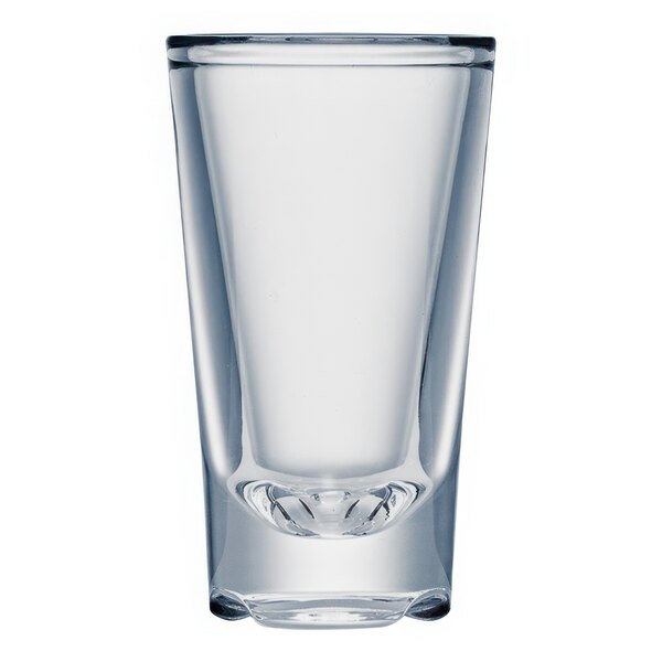 A clear plastic shot glass with a curved bottom.