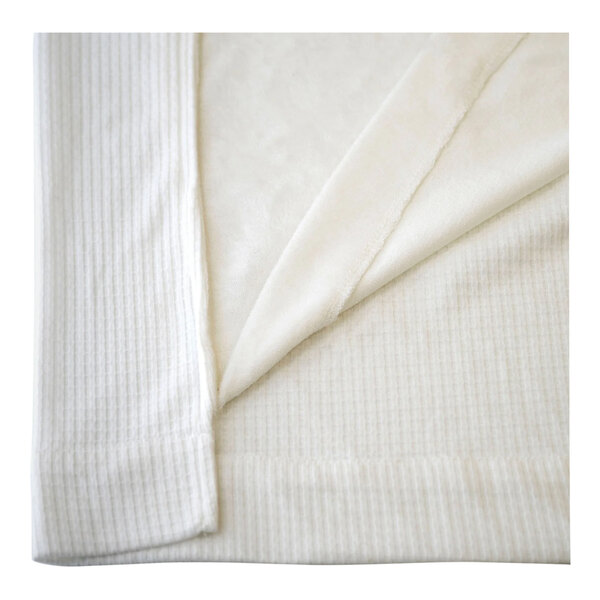A close-up of a white waffle cloth with a white edge.
