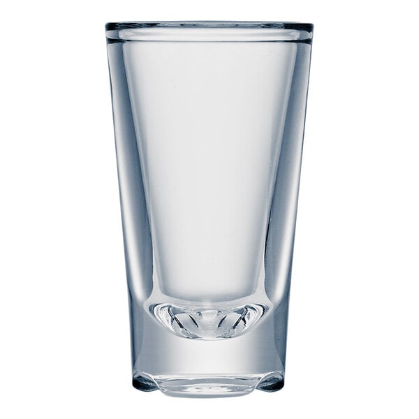 A Strahl Design clear plastic shot glass with a curved bottom on a white background.