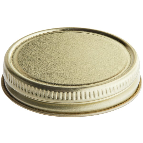 A 48/400 gold metal lid with a plastisol liner on white background.