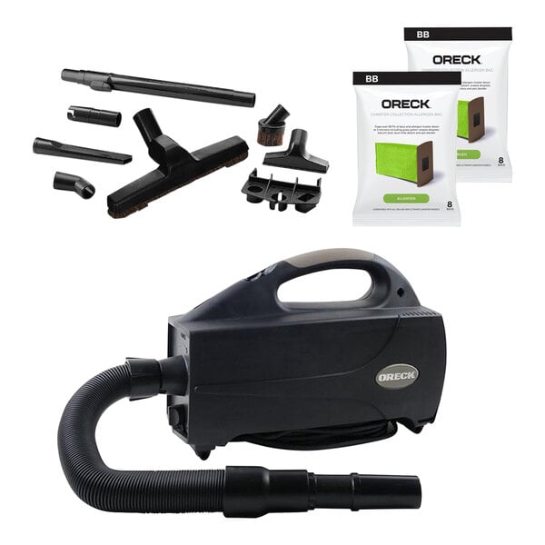 A black Oreck BB1200DB Compact Canister Vacuum with accessories including a hose and bag.