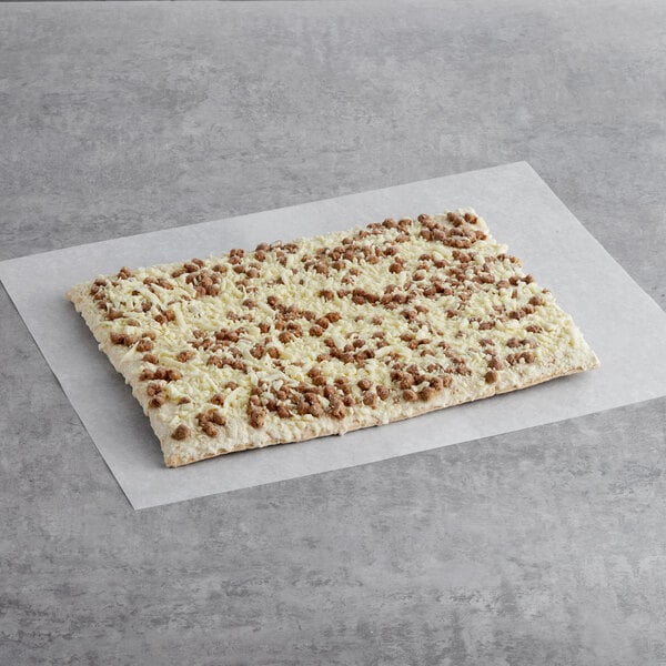 A rectangular white and brown Tony's Whole Grain Turkey Sausage and Country Gravy Breakfast Pizza square on a white surface.