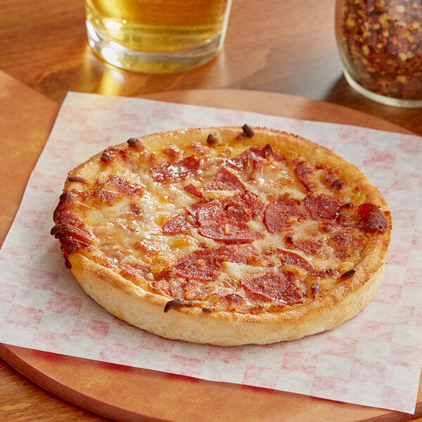 A Tony's Deep Dish Pepperoni Pizza on a wooden cutting board.