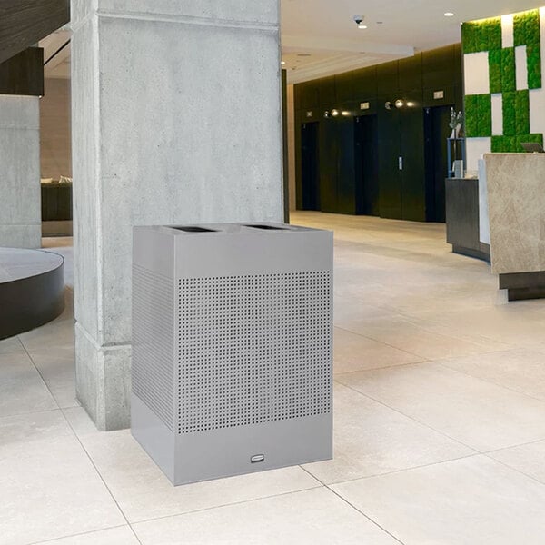 A Rubbermaid Silhouettes steel dual-stream trash can in stardust silver.