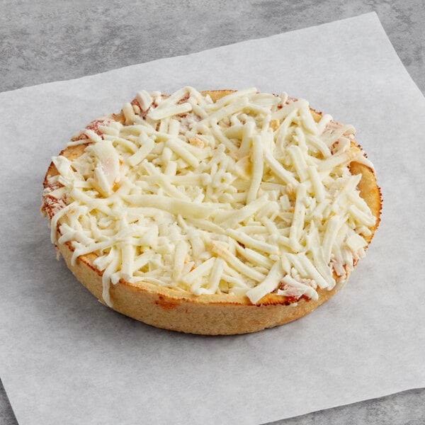 An Individually wrapped Tony's whole grain deep dish cheese pizza on a paper.