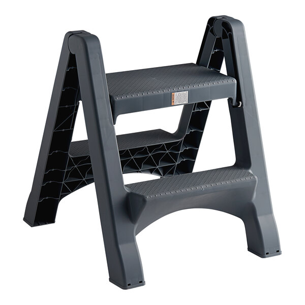 A black folding plastic step stool with a handle.