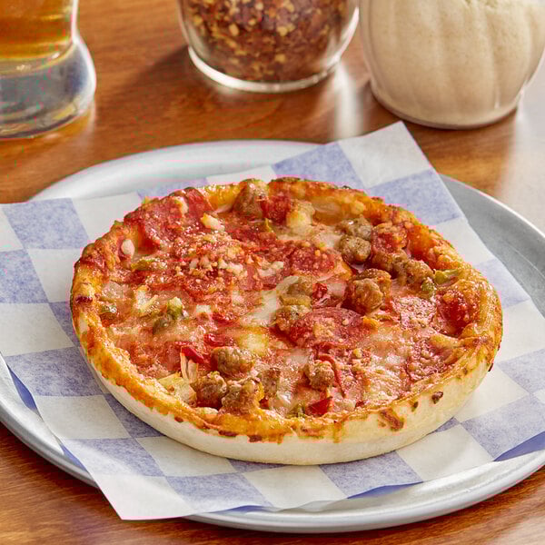 A Tony's Individually Wrapped Deep Dish Supreme Pizza on a plate.