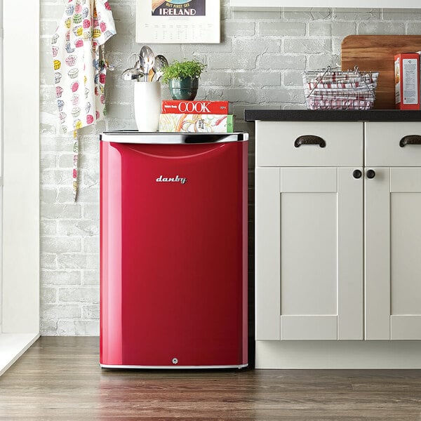 A Danby metallic red refrigerator in a kitchen.