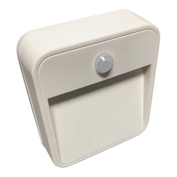 A white plastic box with a circular pattern on the door and a light inside.