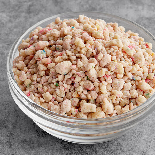 A bowl of cereal topped with Yum Crumbs Birthday Cake crumb topping.