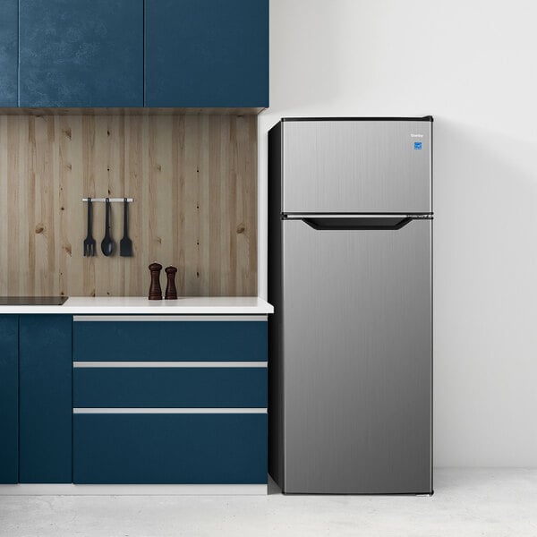 A Danby stainless steel two door reach-in refrigerator in a professional kitchen.
