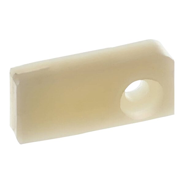 A white rectangular plastic piece with a hole in it.