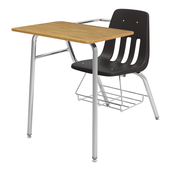 A medium oak Virco student desk with black shell seats on a metal frame.