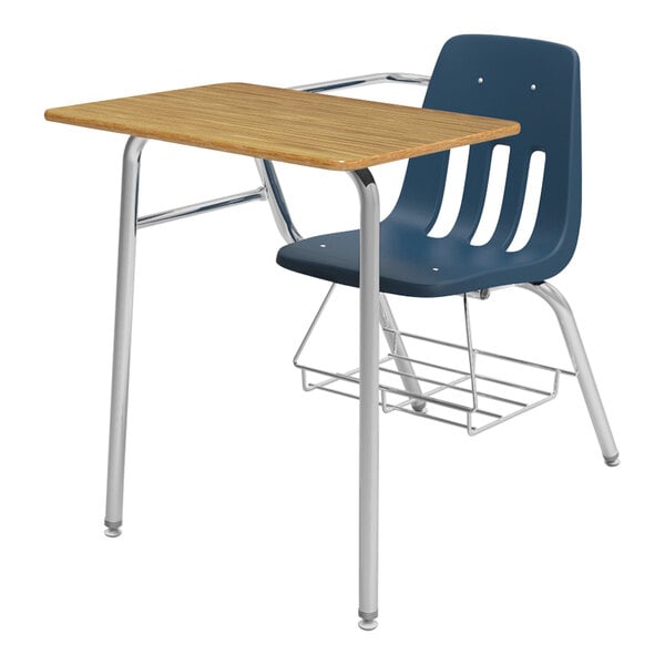 A Virco student desk with a navy blue chair and medium oak desktop with underseat book rack.