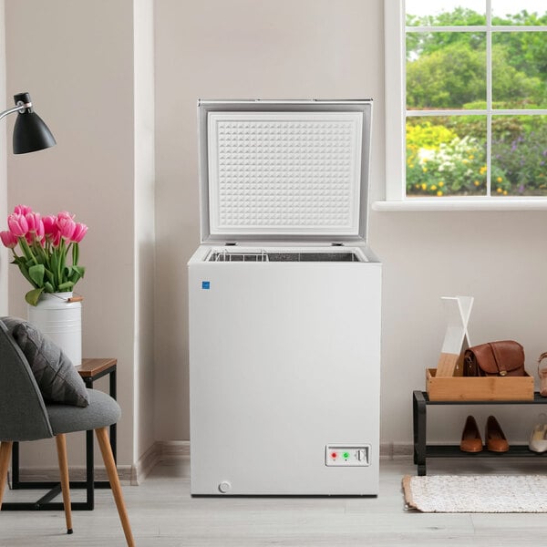 A Danby white chest freezer with the lid open.