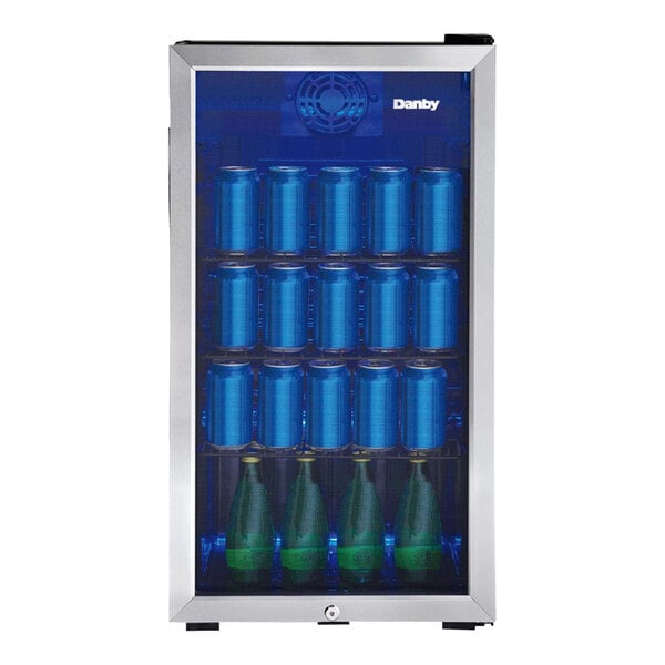 A stainless steel glass door beverage refrigerator filled with cans and bottles.