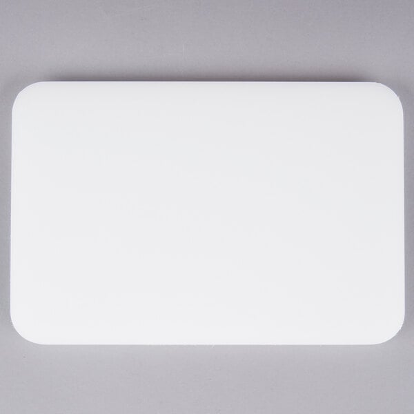A white rectangular San Jamar bar size cutting board.