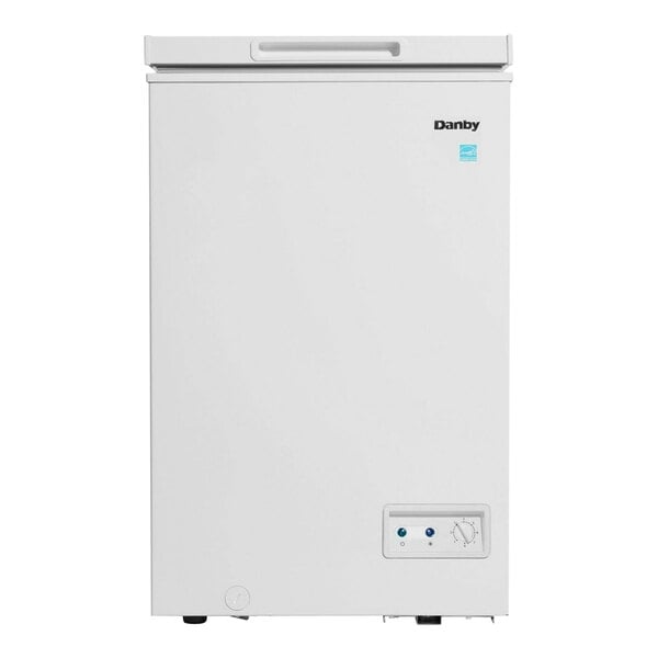 A white Danby chest freezer with a blue sticker on the door.