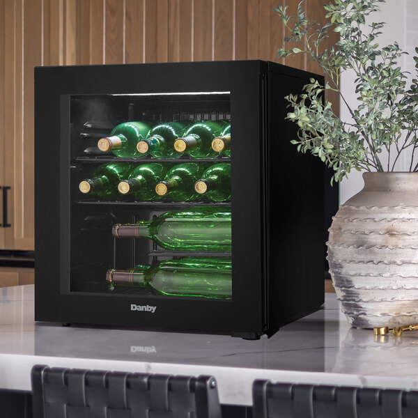 A black Danby countertop wine cooler with a glass door, holding up to 16 bottles.