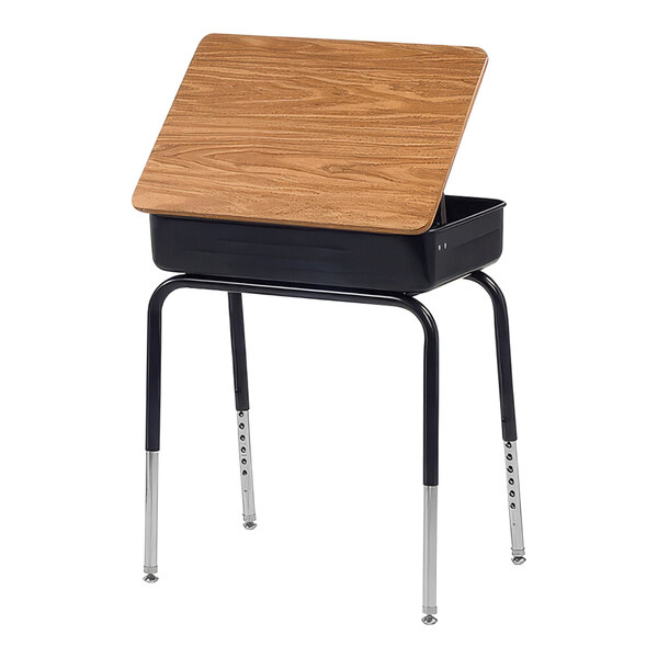 A black school desk with a medium oak wood top and metal book box.