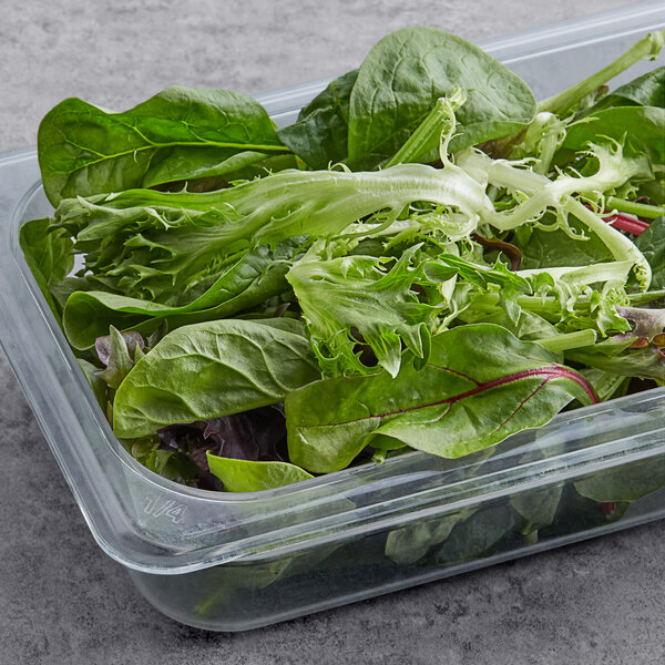 A plastic container of green and red spring mix lettuce.