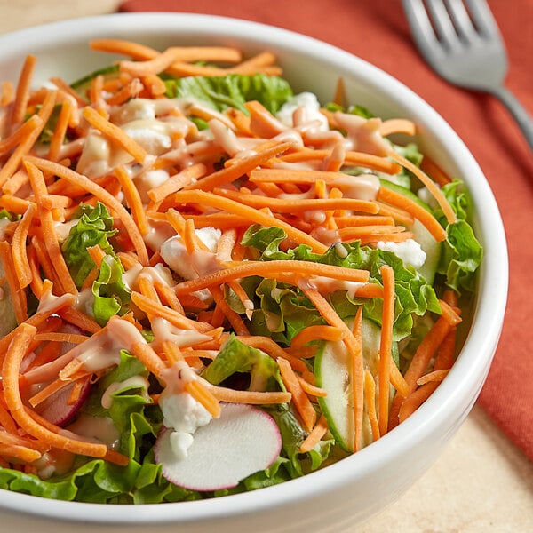 A bowl of salad with shredded carrots and lettuce.